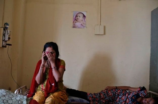 a surrogate mother speaks on a mobile phone with her husband inside the clinic of akanksha ivf center in anand town about 70 km 44 miles south from the western indian city of ahmedabad august 27 2013 photo reuters