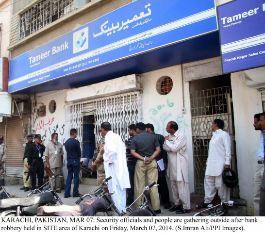 security and bank officials gather outside the tameer bank which was burgled on friday photo ppi security and bank officials gather outside the tameer bank which was burgled on friday photo ppi