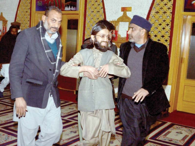 security officials haul away shuhada foundation spokesman ihtisham ahmed photo mudassar raja express security officials haul away shuhada foundation spokesman ihtisham ahmed photo mudassar raja express