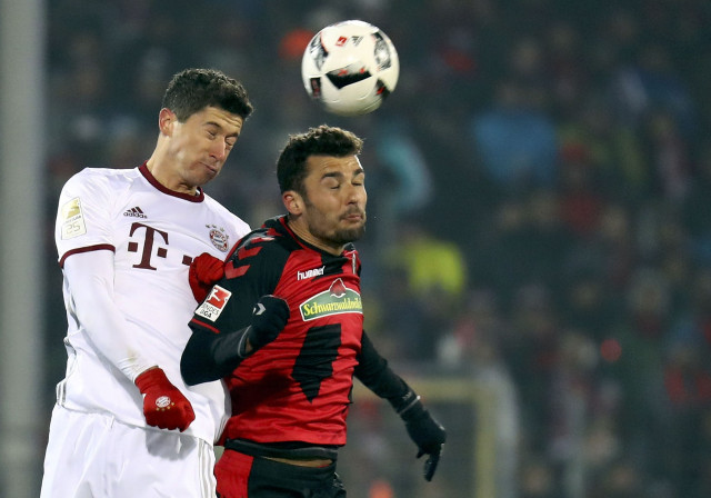 freiburg 039 s manuel gulde in action with bayern munich 039 s robert lewandowski during the match photo reuters freiburg 039 s manuel gulde in action with bayern munich 039 s robert lewandowski during the match photo reuters