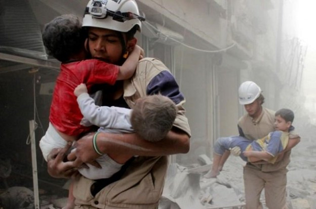 members of the syria civil defence rescueing children photo reuters members of the syria civil defence rescueing children photo reuters