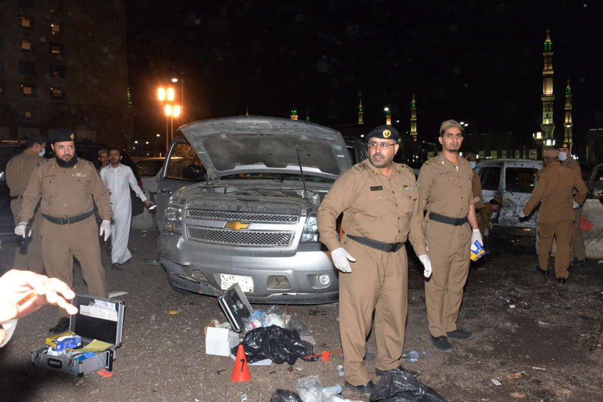 saudi security personel gather at the site of the suicide attack near the security headquarters of the prophet 039 s mosque in medina city on july 4 2016 photo afp