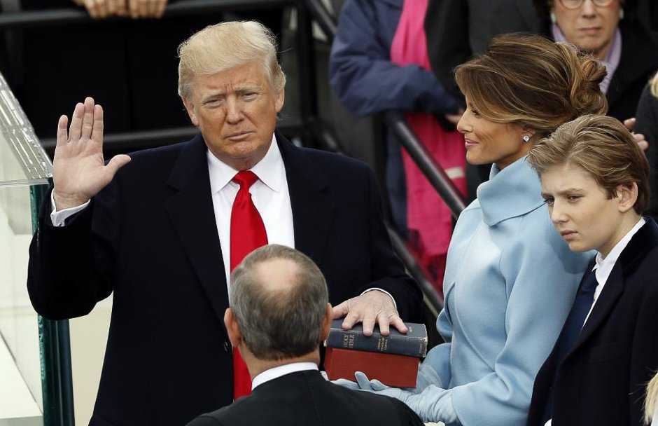 donald trump takes the oath of office with his wife melania and son barron at his side photo afp