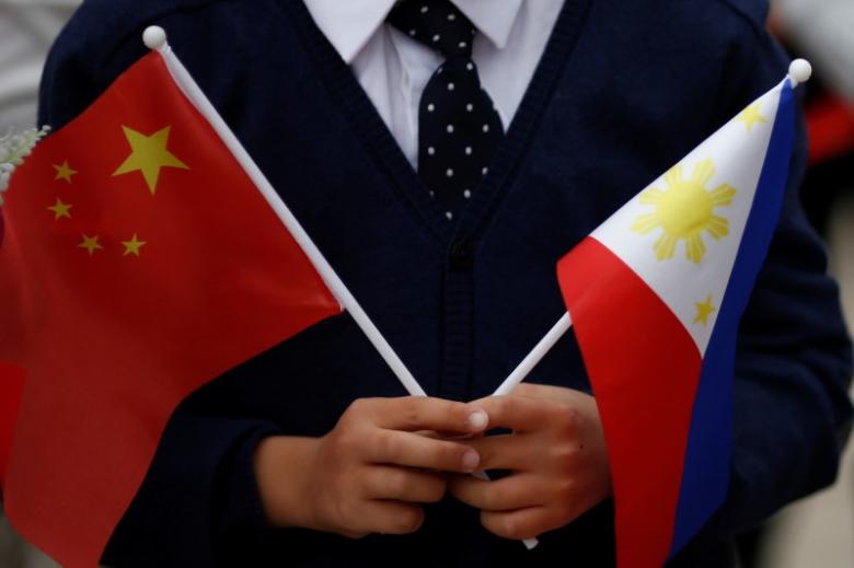 a child holds national flags of china and the philippines before president of the philippines rodrigo duterte and china 039 s president xi jinping attend a welcoming ceremony at the great hall of the people in beijing china october 20 2016 photo reuters