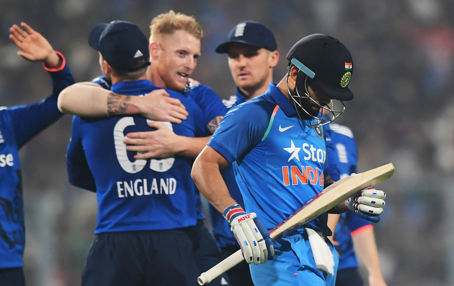 india 039 s captain virat kohli r reacts after losing his wicket as england 039 s ben stokes c celebrates with teammates during the third one day international match between india and england at the eden gardens cricket stadium in kolkata on january 22 2017 photo afp