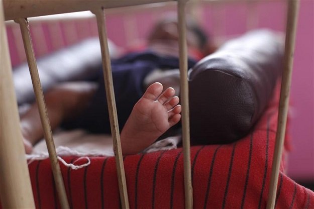 a baby girl is seen lying in a cradle inside the life line trust orphanage in salem in the southern indian state of tamil nadu june 20 2013 photo reuters