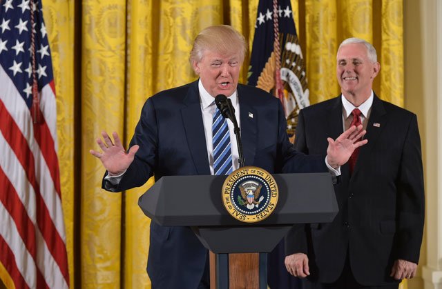 us president donald trump speaks as vice president mike pence watches before the swearing in of the white house senior staff at the white house on january 22 2017 in washington dc photo afp