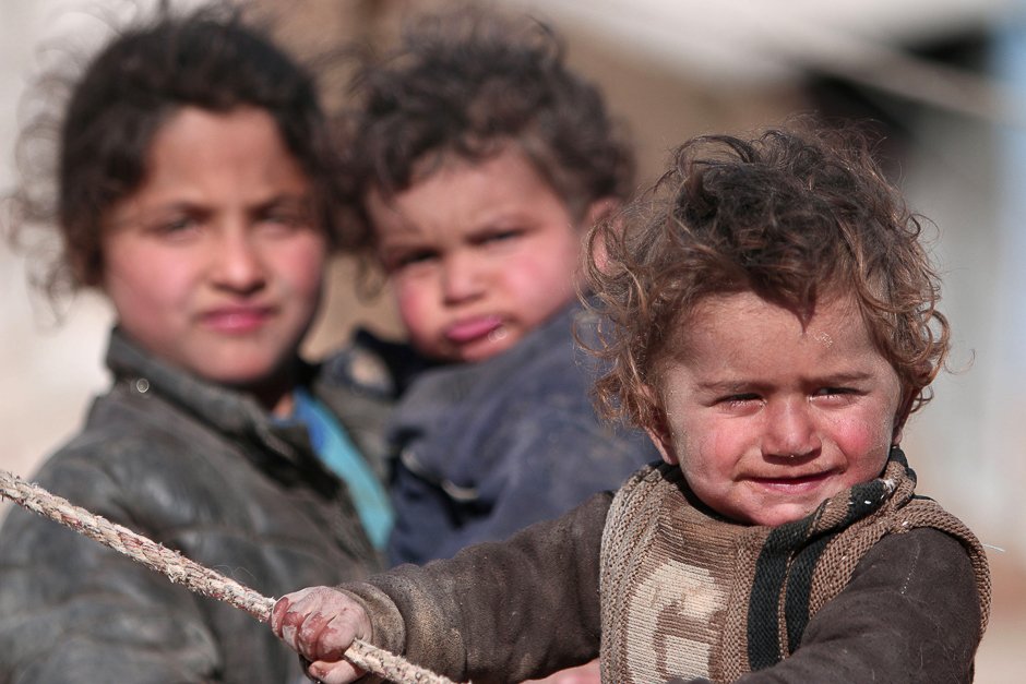 internally displaced syrian children who fled raqqa city stand near their tent in ras al ain province syria photo reuters