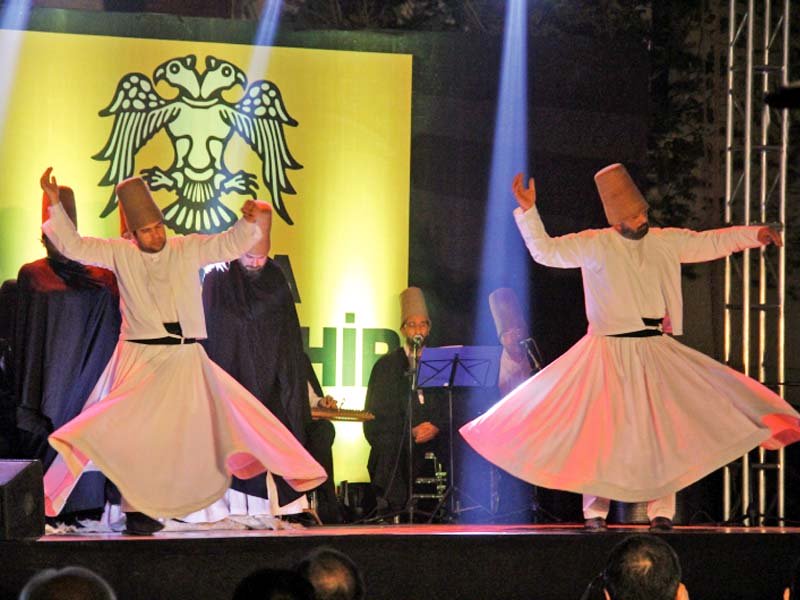 whirling dervishes perform on stage at the fundraiser photo ayesha mir express