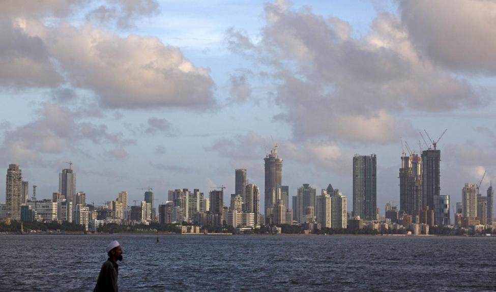 a man walks at the seafront as scattered clouds are seen over mumbai 039 s skyline india june 10 2015 photo reuters