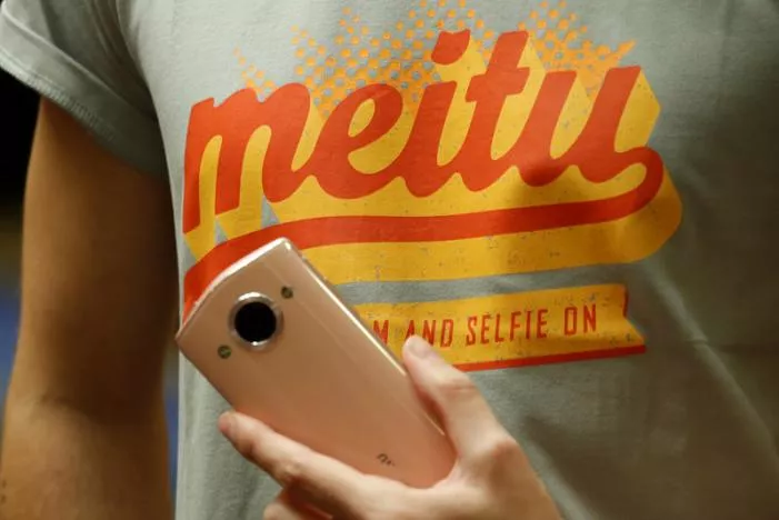 a model poses with a meitu smartphone during meitu ipo news conference in hong kong china december 2 2016 photo reuters a model poses with a meitu smartphone during meitu ipo news conference in hong kong china december 2 2016 photo reuters
