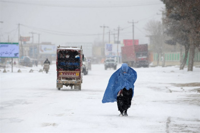 a burqa clad afghan woman makes her way as snow falls in the city of mazar i sharif afghanistan photo afp a burqa clad afghan woman makes her way as snow falls in the city of mazar i sharif afghanistan photo afp