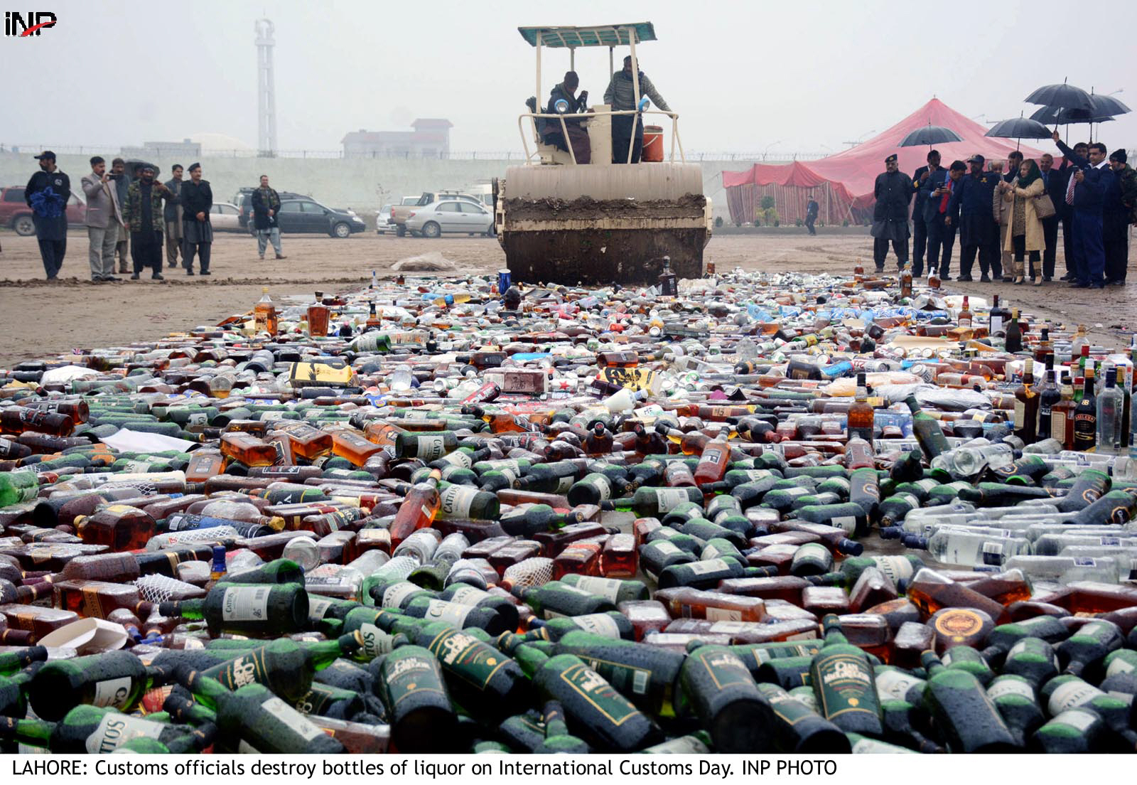 customs officials destroy bottles of liquor on international customs day photo inp