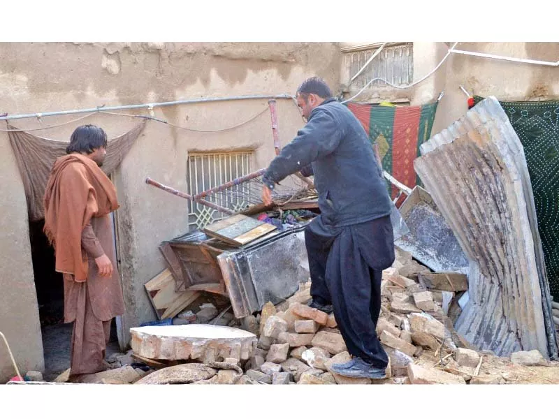 men busy in rescue work after the roof of a house collapsed due to rain in the nawa killi area photo inp