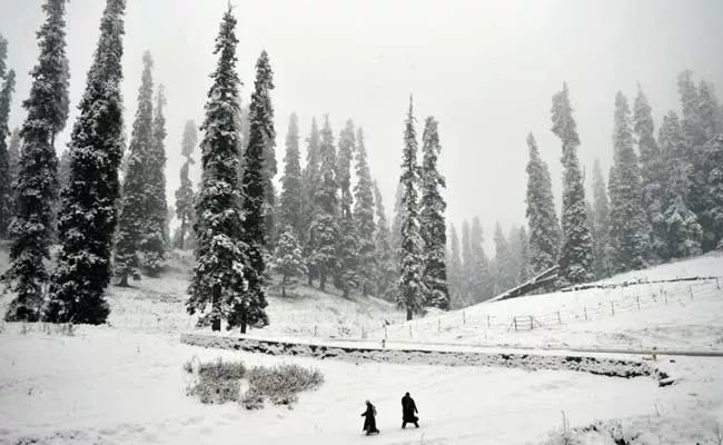 kashmiri walkers cross a snow covered area at gulmarg some 55 km north of srinagar photo afp kashmiri walkers cross a snow covered area at gulmarg some 55 km north of srinagar photo afp