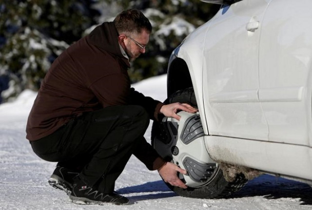 a man puts automatic snow chains on a car tyre at the ski resort ovcarna near the village of karlova studanka czech republic january 19 2017 photo reuters a man puts automatic snow chains on a car tyre at the ski resort ovcarna near the village of karlova studanka czech republic january 19 2017 photo reuters