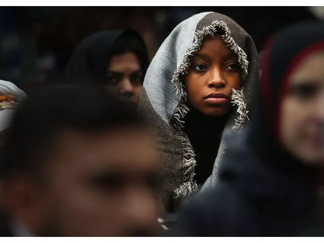 a woman listens to a speaker as area muslims and local immigration activists participate in a prayer and rally against president donald trump 039 s immigration policies on january 27 2017 in new york city photo afp a woman listens to a speaker as area muslims and local immigration activists participate in a prayer and rally against president donald trump 039 s immigration policies on january 27 2017 in new york city photo afp
