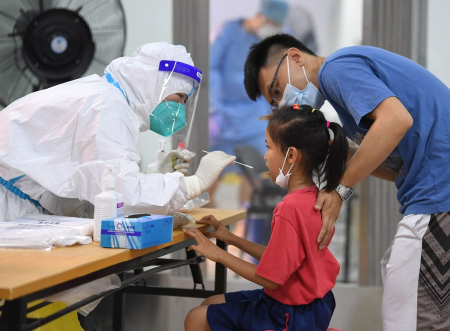 a medical worker collects swab sample for nucleic acid testing in liwan district of guangzhou south china s guangdong province may 26 2021 photo xinhua file