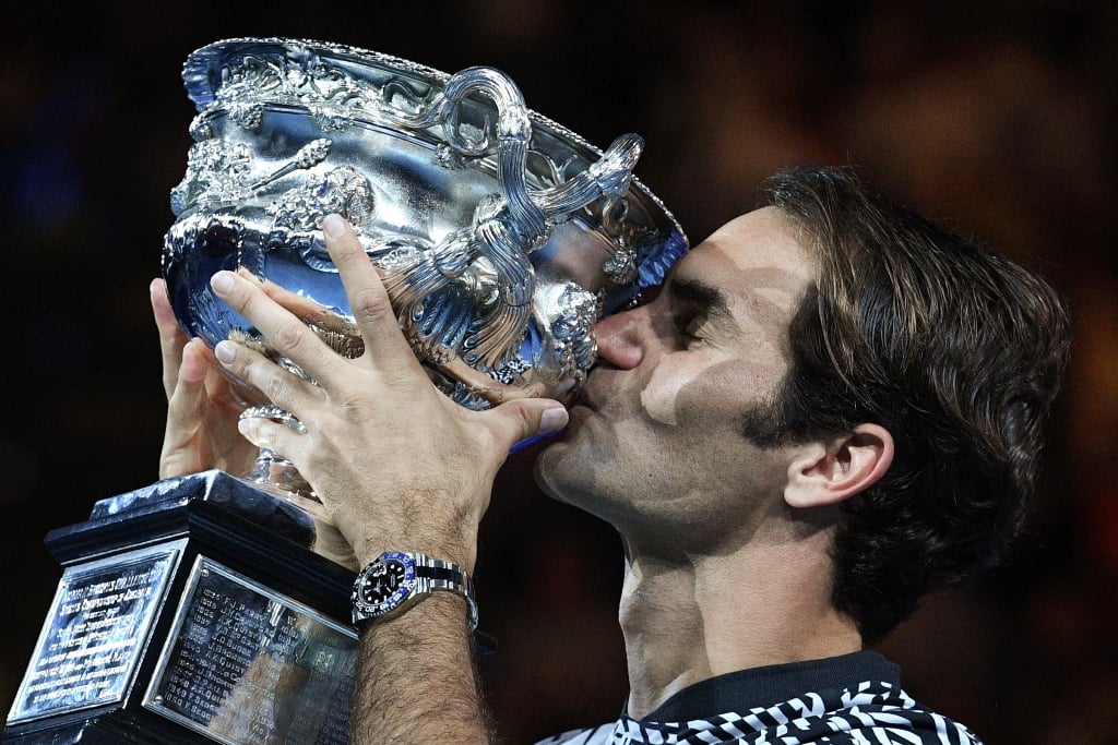 roger federer celebrates with the championship trophy in melbourne on january 29 2017 photo afp