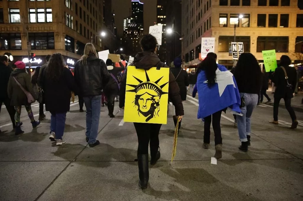 the statue of liberty is pictured on a sign as people march in support of immigrants and refugees in seattle washington on january 29 2017 photo afp the statue of liberty is pictured on a sign as people march in support of immigrants and refugees in seattle washington on january 29 2017 photo afp