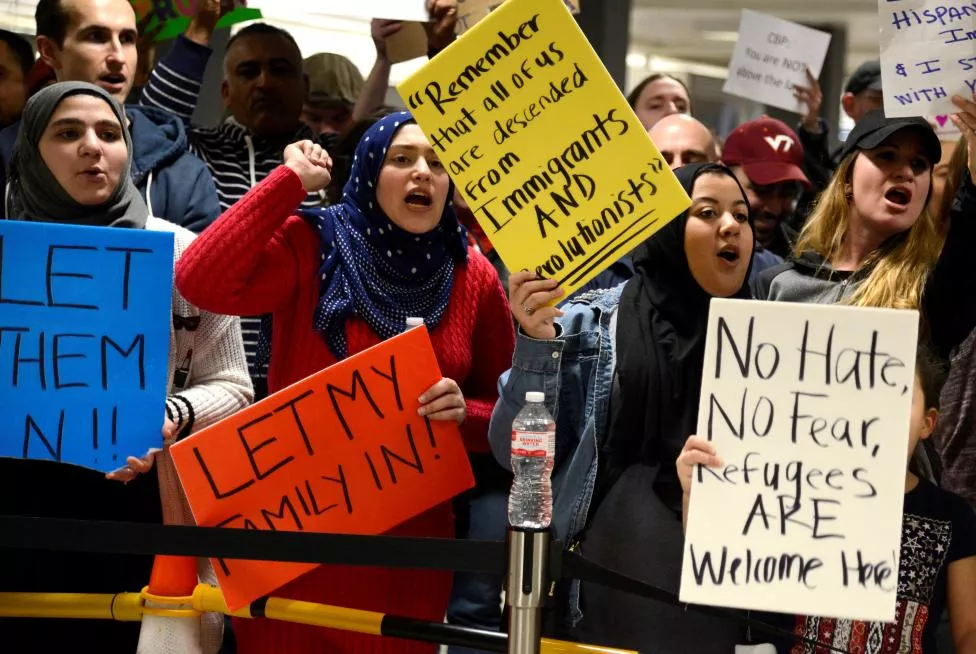dozens of pro immigration demonstrators cheer and hold signs as international passengers arrive at dulles international airport to protest president donald trump 039 s executive order barring visitors refugees and immigrants from certain countries to the united states in chantilly virginia in suburban washington reuters mike theiler dozens of pro immigration demonstrators cheer and hold signs as international passengers arrive at dulles international airport to protest president donald trump 039 s executive order barring visitors refugees and immigrants from certain countries to the united states in chantilly virginia in suburban washington reuters mike theiler