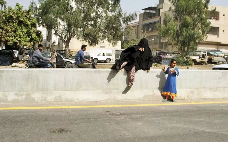 a woman and a girl find a way to cross the newly constructed sadequain underpass which was inaugurated on tuesday photo online a woman and a girl find a way to cross the newly constructed sadequain underpass which was inaugurated on tuesday photo online