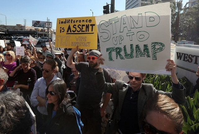 protesters hold signs during a demonstration against u s president donald trump outside the office of sen dianne feinstein d ca on january 31 2017 in los angeles california photo afp protesters hold signs during a demonstration against u s president donald trump outside the office of sen dianne feinstein d ca on january 31 2017 in los angeles california photo afp