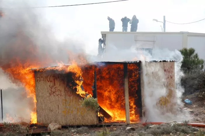 protesters stand atop a roof as a shed burns during an eviction by israeli police of residents from the israeli settler outpost of amona in the occupied west bank february 1 2017 photo reuters protesters stand atop a roof as a shed burns during an eviction by israeli police of residents from the israeli settler outpost of amona in the occupied west bank february 1 2017 photo reuters