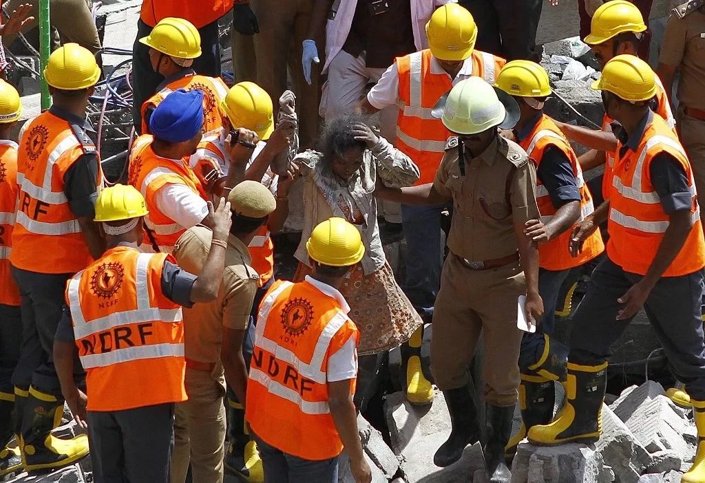 indian rescue workers assist a survivor from the rubble of a collapsed multi storeyed building in porur town situated on the outskirts of chennai photo afp indian rescue workers assist a survivor from the rubble of a collapsed multi storeyed building in porur town situated on the outskirts of chennai photo afp