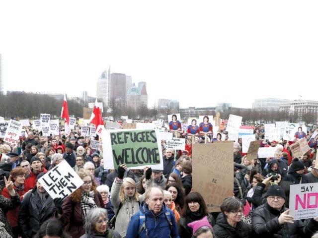 protesters hold placards during an anti trump rally in the hague photo afp protesters hold placards during an anti trump rally in the hague photo afp