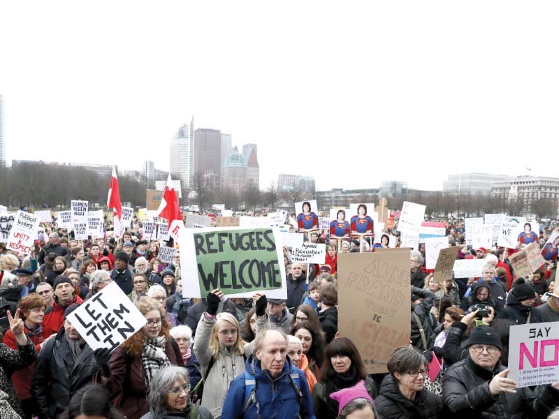 protesters hold placards during an anti trump rally in the hague photo afp