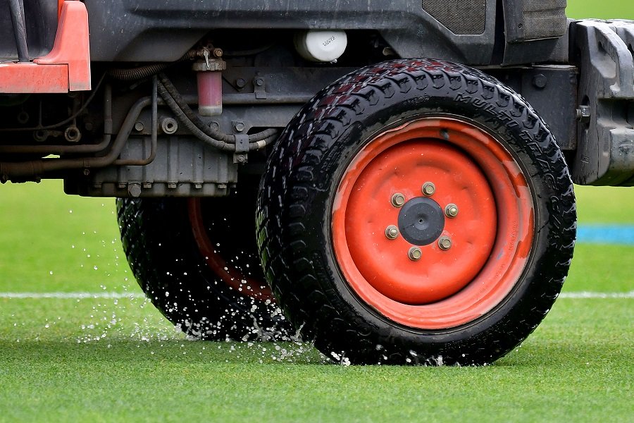 a tractor tyre throws up water on the outfield at mclean park in napier on february 2 2017 photo afp