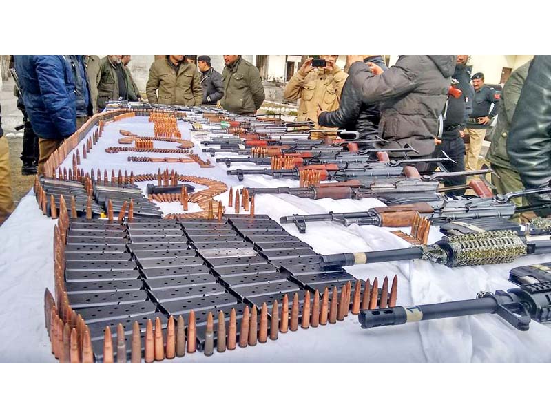 policemen show weapons seized in raids in gilgit and chilas towns photo express