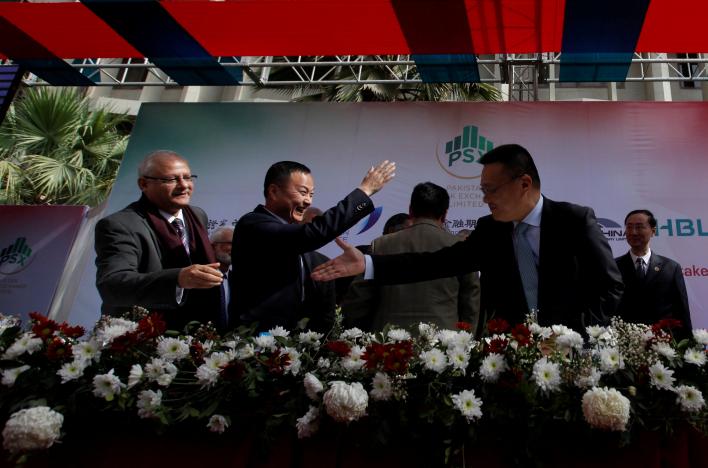 nadeem naqvi l managing director of the pakistan stock exchange shakes hands with chinese officials after signing an agreement for a chinese led consortium to buy a strategic stake in psx in karachi pakistan january 20 2017 photo reuters