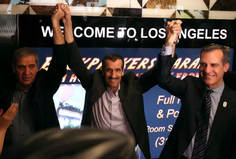 iranian citizen ali vayeghan c stands with his brother hossein vayeghan l and los angeles mayor eric garcetti as he arrives at los angeles international airport on february 2 2017 photo afp iranian citizen ali vayeghan c stands with his brother hossein vayeghan l and los angeles mayor eric garcetti as he arrives at los angeles international airport on february 2 2017 photo afp