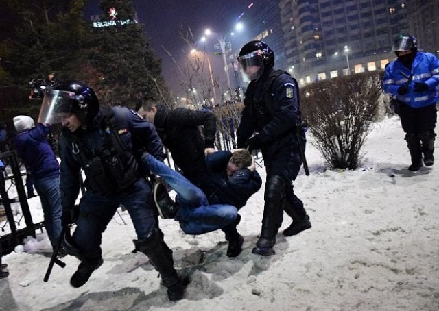 romanian riot police evacuate a protester during a demonstration against controversial decrees to pardon corrupt politicians and decriminalize other offenses in front of the government headquarters in bucharest on february 1 2017 photo afp romanian riot police evacuate a protester during a demonstration against controversial decrees to pardon corrupt politicians and decriminalize other offenses in front of the government headquarters in bucharest on february 1 2017 photo afp