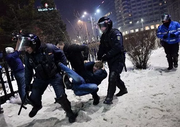 romanian riot police evacuate a protester during a demonstration against controversial decrees to pardon corrupt politicians and decriminalize other offenses in front of the government headquarters in bucharest on february 1 2017 photo afp romanian riot police evacuate a protester during a demonstration against controversial decrees to pardon corrupt politicians and decriminalize other offenses in front of the government headquarters in bucharest on february 1 2017 photo afp