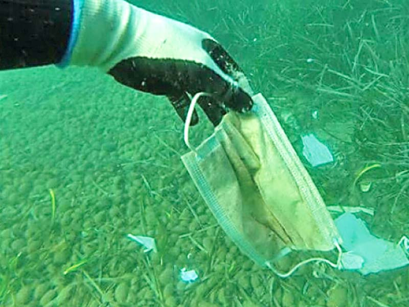 a diver shows facemasks lying in the seabed along the coastline of karachi photo express