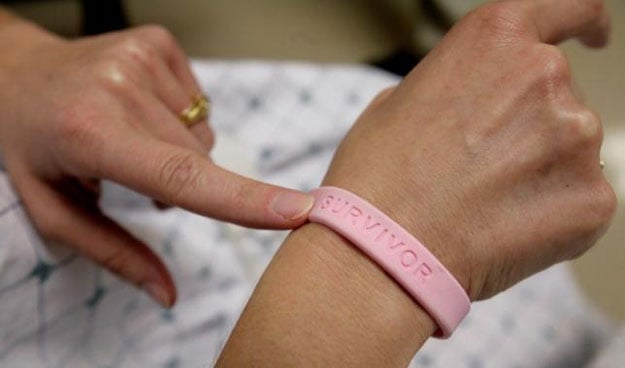 a cancer patient shows off her breast cancer survivor bracelet photo reuters
