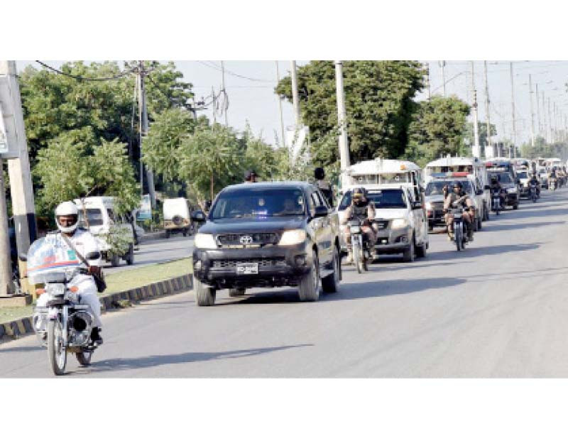 rangers and police contingents hold a flag march on the eve of the na by polls in the malir area on saturday photo nni