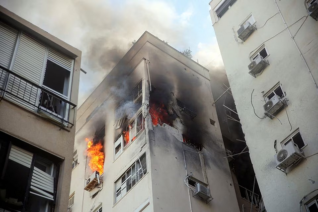 A building is ablaze following rocket attacks from the Gaza Strip, in Tel Aviv, Israel October 7: Reuters