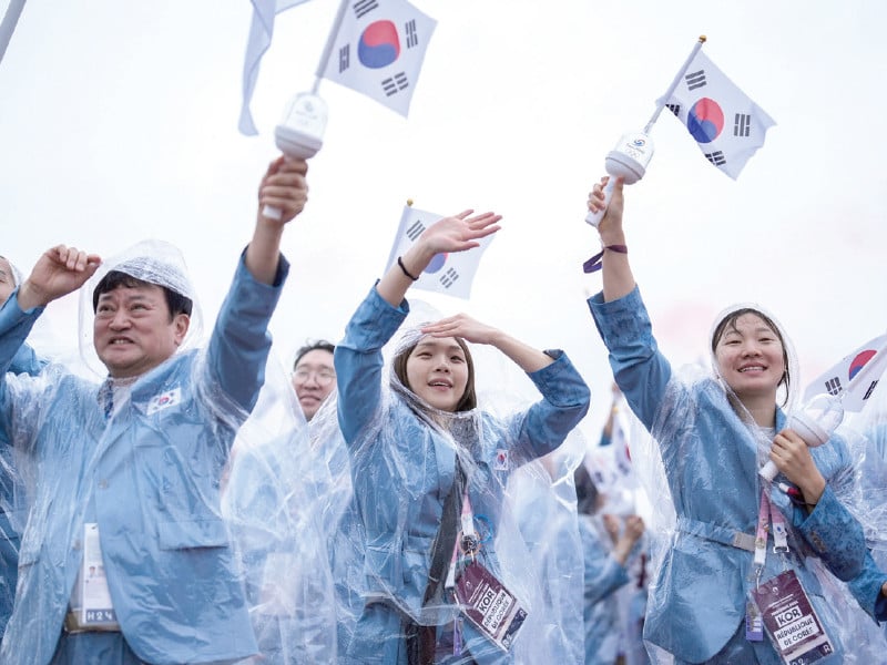 south korea s delegation erroneously introduced as north koreans sail in a boat along the river seine during the opening ceremony on friday photo afp
