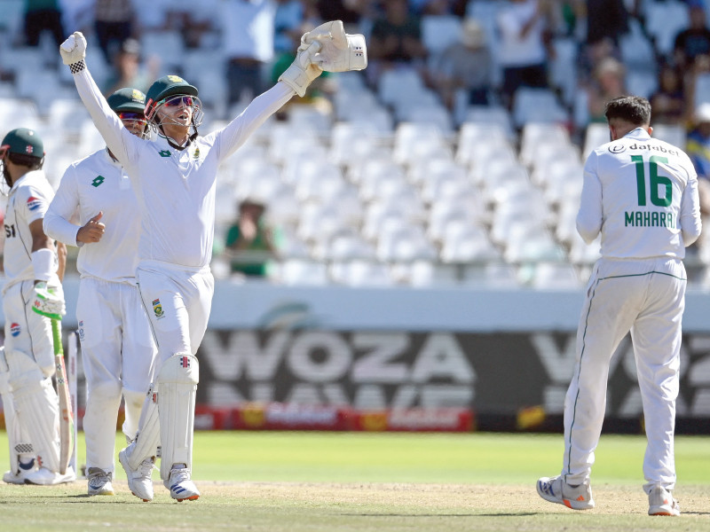 south africa s kyle verreynne 3rd l celebrates the dismissal of pakistan s mohammad rizwan l by keshav maharaj r on fourth day of second test at newlands photo afp