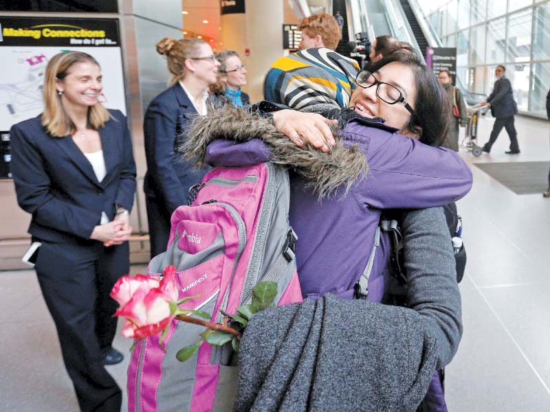 iranian student samira asgari hugs her friend after being cleared to enter the us in boston photo reuters