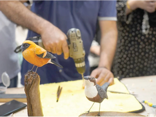 participants learn woodcarving techniques at the pocket knife woodcarving workshop organised by the pakistan national council of arts visual art division in islamabad photo inp