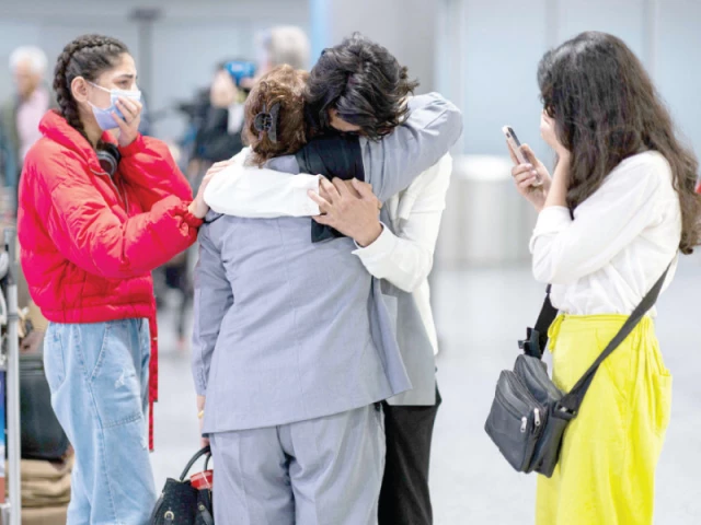 flight passengers of afghan families who fled the taliban are welcomed at the airport after arriving in hannover langenhagen germany photo afp flight passengers of afghan families who fled the taliban are welcomed at the airport after arriving in hannover langenhagen germany photo afp