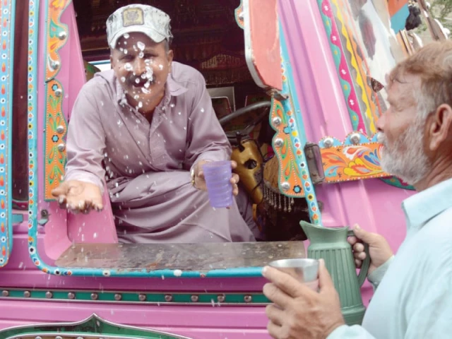 as summer makes its final bow the city swelters one last time a minibus driver drenched in sweat pauses for a drink his routine slowed by heat and thirst photo express