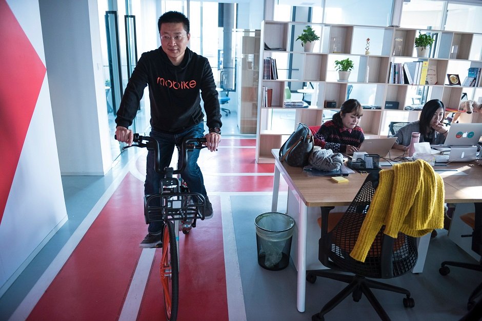 davis wang ceo of mobike riding a bicycle in the headquarters of mobike in shanghai photo afp