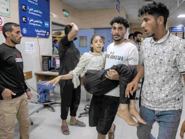 a girl who was injured following a reported israeli strike on a tent is carried by a man for treatment at nasser medical complex in khan yunis photo afp a girl who was injured following a reported israeli strike on a tent is carried by a man for treatment at nasser medical complex in khan yunis photo afp