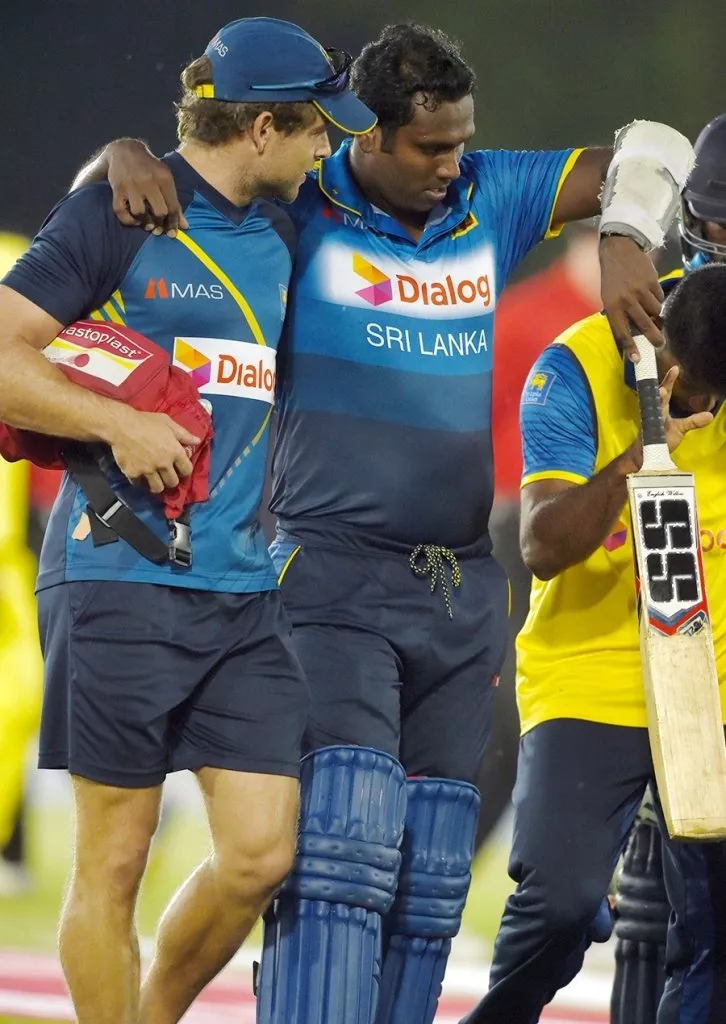 angelo mathews being helped off from the field photo afp angelo mathews being helped off from the field photo afp